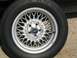 1999 Ford Crown Victoria - This is a close-up of a Ford wheel with a distinctive wire-spoke design.