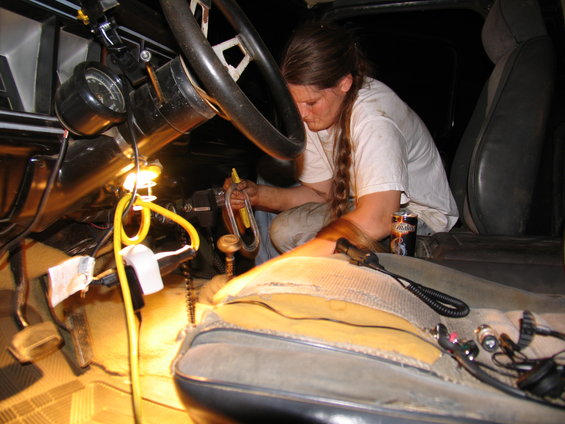 1978 Ford Bronco interior with person working on dashboard and steering column