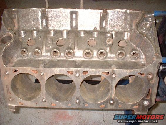 Cast iron V8 engine block with cylinder bores visible