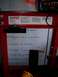 1986 Ford F-250 - A red hydraulic press is shown with a whiteboard covered in handwritten notes and diagrams.