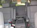 2006 Nissan Armada - The interior of a vehicle shows multiple rows of gray leather seats and a center console.