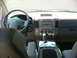 2006 Nissan Armada - The interior of a car shows the steering wheel, dashboard, and center console with a gear shifter.
