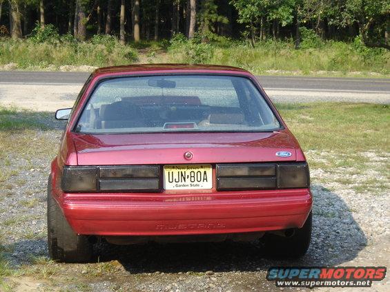 Red Ford Mustang, rear view. License plate UJN-80A from New Jersey