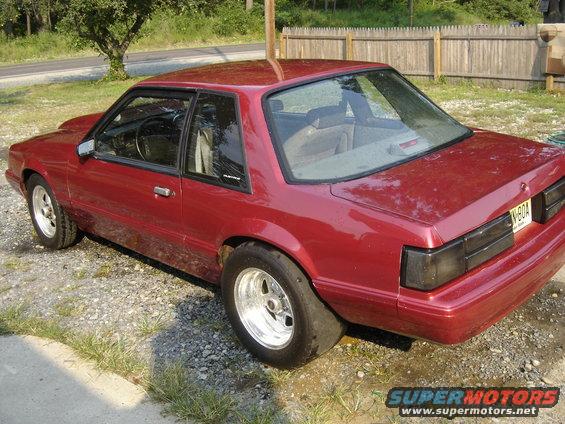 Red coupe with drag tires, 3/4 front view