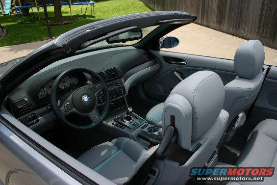 Interior view of a BMW M3 convertible showing the dashboard, steering wheel, seats, and center console
