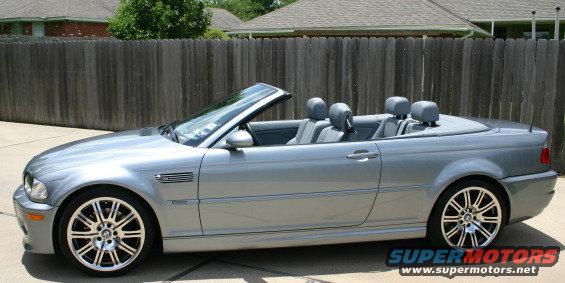 Silver BMW M3 convertible parked outside, top down, showing grey interior