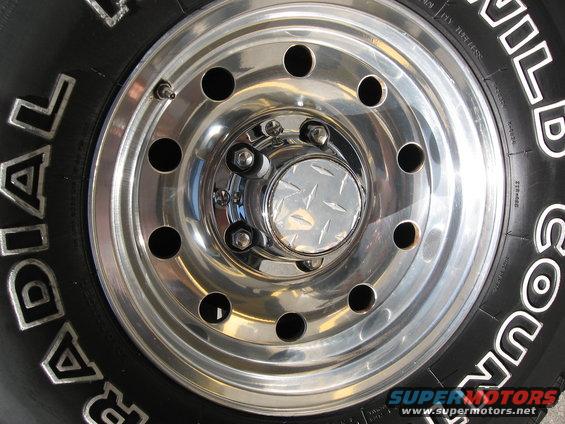 Chrome wheel with diamond plate center cap and tire with white lettering