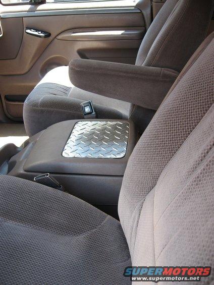 1994 Ford Bronco interior showing front seats, armrest, and center console with diamond plate accent