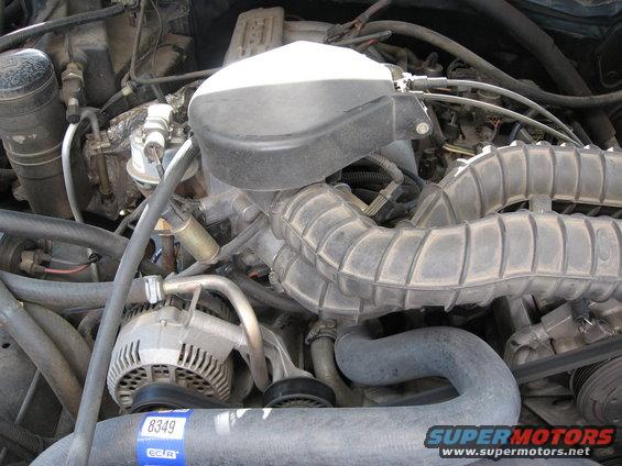 1994 Ford Bronco engine bay with alternator and air intake hoses