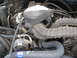 1994 Ford Bronco - Close-up view of the engine bay of a 1994 Ford Bronco, showing the alternator and air intake system.