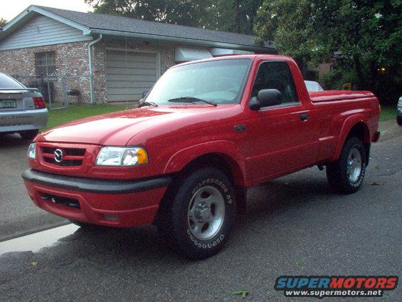Red pickup truck, 3/4 front view. Likely a 1998 Mazda B-Series