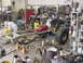 1969 Ford Bronco - A vehicle frame, engine, and large tire are visible in a workshop setting.