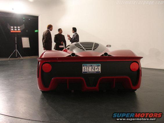 Rear view of a red sports car with a New York license plate reading 612 P4-5