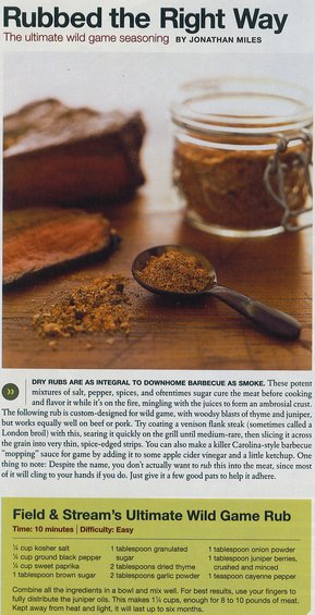 Meat and a jar of seasoning on a wooden surface