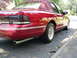 1995 Ford Crown Victoria - Rear view of a red 1995 Ford Crown Victoria sedan a maroon vinyl top and chrome trim.