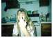 1989 Ford Bronco - A woman in a kitchen setting gestures with her middle finger towards the camera.