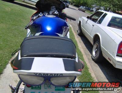 2001 Yamaha R1 motorcycle rear with blue gas tank and white accents. License plate visible