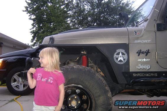 Girl in pink shirt standing next to a 2004 Jeep Wrangler with "SPORT" and "4x4" decals