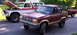 1979 Ford F-250 - Two Ford trucks, a Bronco II and an F-Series, are parked on a street with one's hood open.