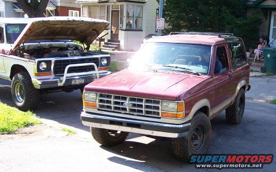 Red Ford Bronco II front 3/4 view. Grille indicates 1989 model year