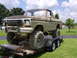 1978 Ford Bronco - A heavily modified 1978 Ford Bronco, caked in mud, is loaded onto a trailer.