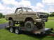 1978 Ford Bronco - This heavily modified 1978 Ford Bronco, caked in mud, is being transported on a trailer.