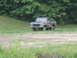 1978 Ford Bronco - This lifted 1978 Ford F-Series pickup truck is shown off-road in a grassy area.