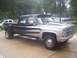 2005 Dodge 1500 - This dually pickup truck has a two-tone paint scheme with silver racing stripes and a black top section.