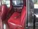 2005 Dodge 1500 - Interior view of a truck's red velour seats and wood-grain trim, with other vehicles seen outside.