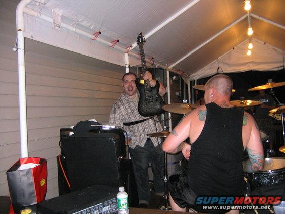 Man holding electric guitar at outdoor party