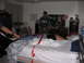 1986 Ford Mustang - A bedroom scene with people and red tape on the bed.