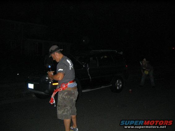 Dark SUV parked at night, side view