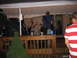 1986 Ford Mustang - A band plays music on an outdoor deck during a party.