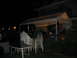 1986 Ford Mustang - An outdoor party is in progress under a large tent at night, with several people mingling.
