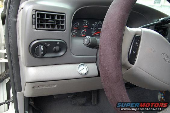 2001 Ford Excursion dashboard with gauges, air vent, light controls, and steering wheel