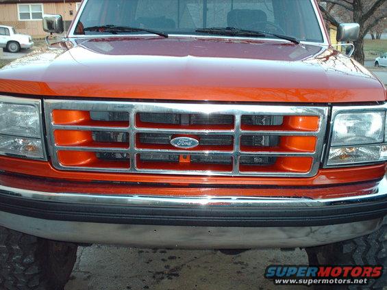 Orange Ford F-350 truck front grille with chrome bumper and headlights