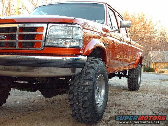 Orange 1991 Ford F-350 front 3/4 view with large tires