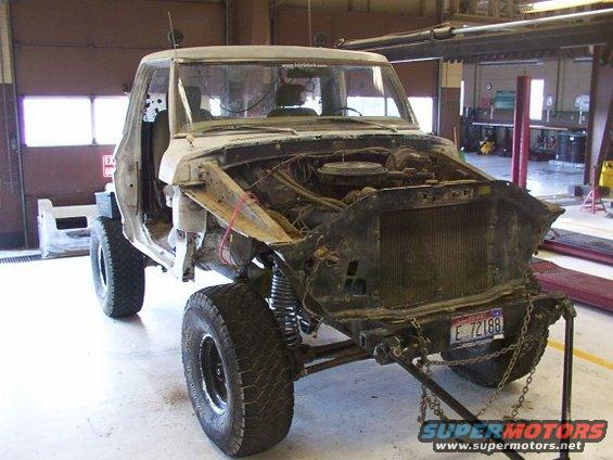 1978 Ford Bronco with hood removed, front end disassembled, in a workshop