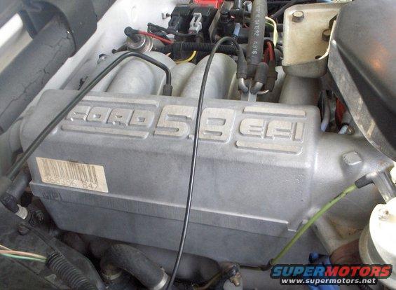 Silver Ford 5.8 EFI intake manifold with a barcode sticker