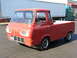 1963 Ford E100 - This red 1963 Ford Econoline pickup truck is shown from a 3q-front angle, its distinctive body style.
