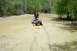 2005 Yamaha GRIZZLY 660 - A rider navigates a muddy trail on a 2005 Yamaha GRIZZLY 660 ATV.