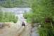2005 Yamaha GRIZZLY 660 - An ATV navigates a challenging dirt path in a wooded, quarry-like environment.