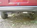 1995 Jeep YJ - Rear view of a vehicle's trailer hitch and bumper assembly, showing the exhaust pipe and tire.