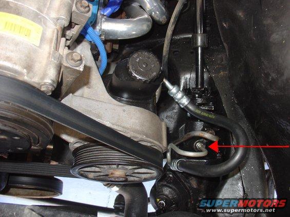 Close-up of vehicle's power steering pump, hoses, and pulley system