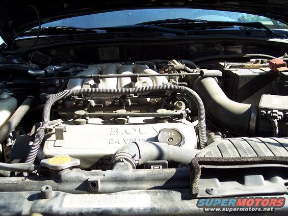 Engine bay with 3.0L 24 valve engine cover and oil cap visible