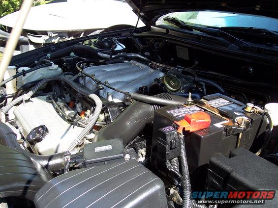 Engine bay with battery and intake manifold visible
