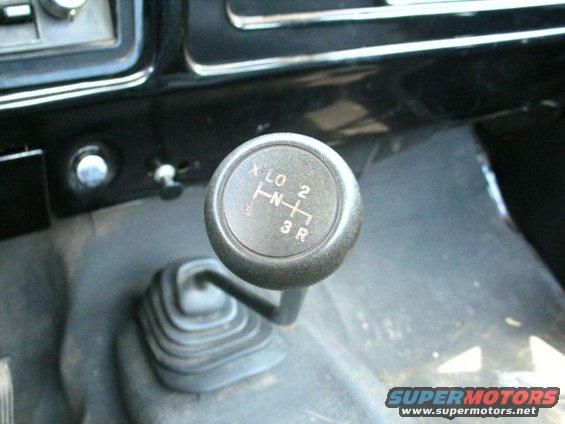 Close-up of a manual transmission shifter with gears labeled 1, 2, 3, R, N, and 4-LO