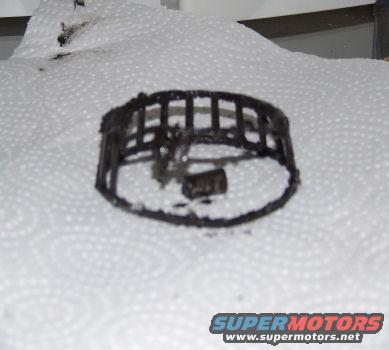 Damaged wheel bearing cage and roller on paper towels