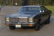 1978 Dodge Monaco - Front view of a 1978 Dodge Monaco sedan on a paved road with trees in the background.
