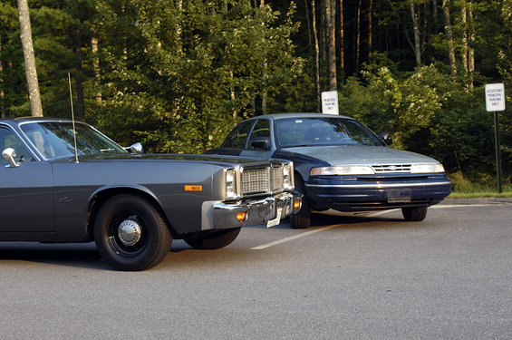 Gray 1978 Dodge Monaco front quarter view, chrome grille, black wheels, parked next to a blue and gray sedan
